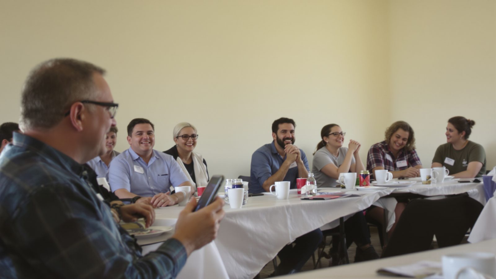 Small-business owners talking over coffee at an early-morning networking breakfast