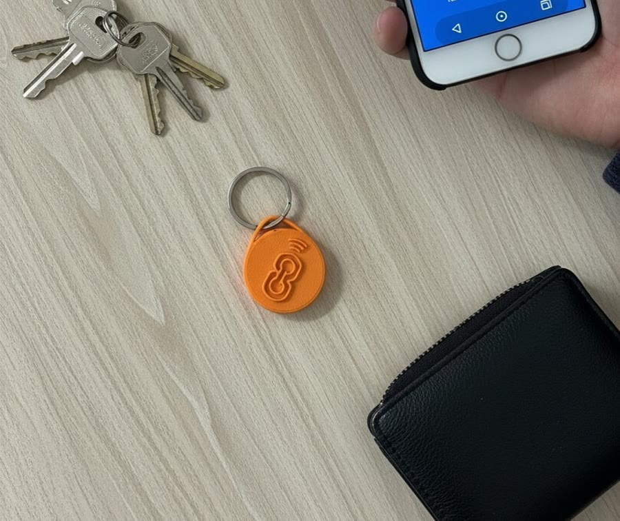 A keychain beside a phone, ready for a tap